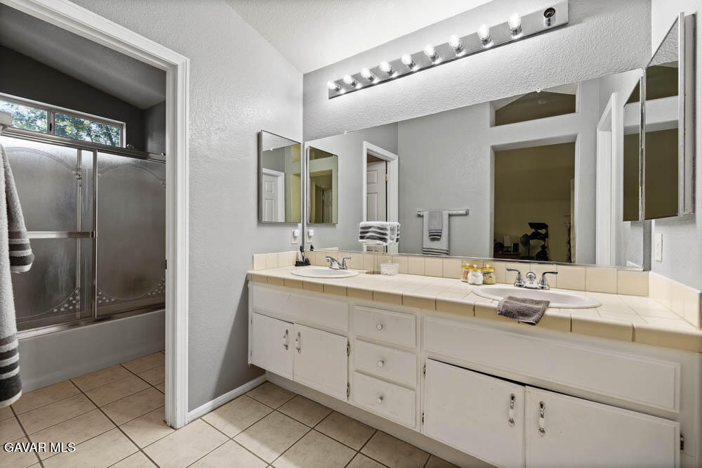 2425 Williams Court Rosamond, CA 93560 - Photo 27 of 35 a bathroom with a double vanity sink and mirror