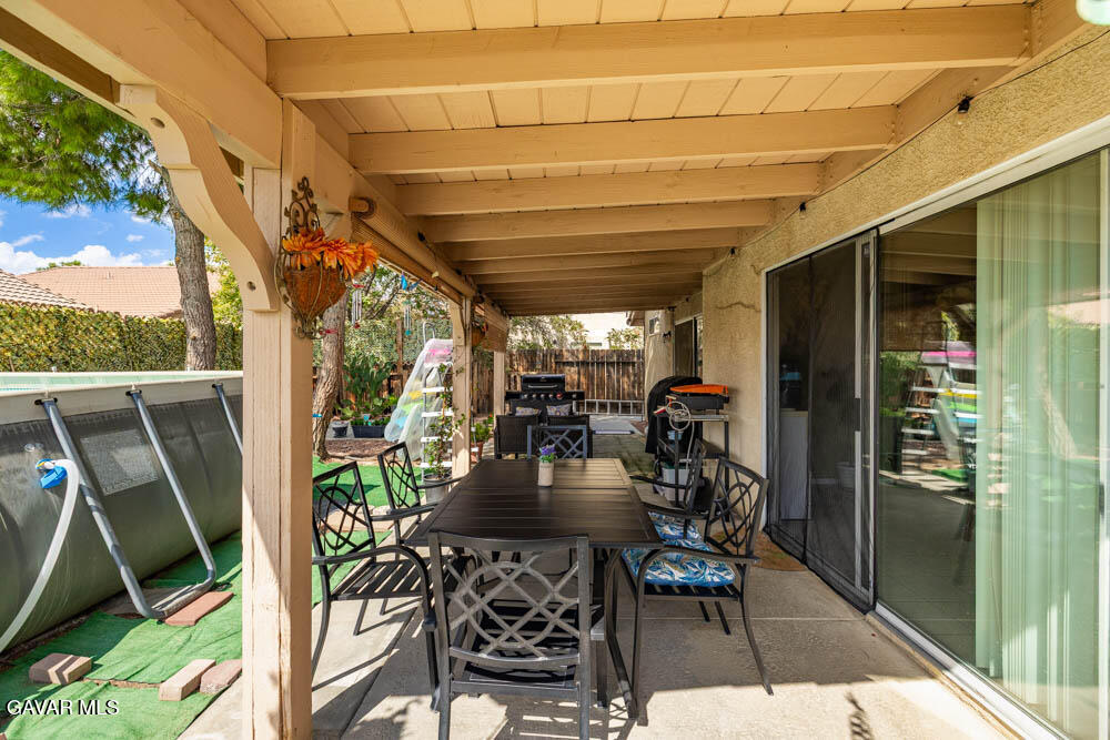2425 Williams Court Rosamond, CA 93560 - Photo 31 of 35 a view of a patio with table and chairs and potted plants