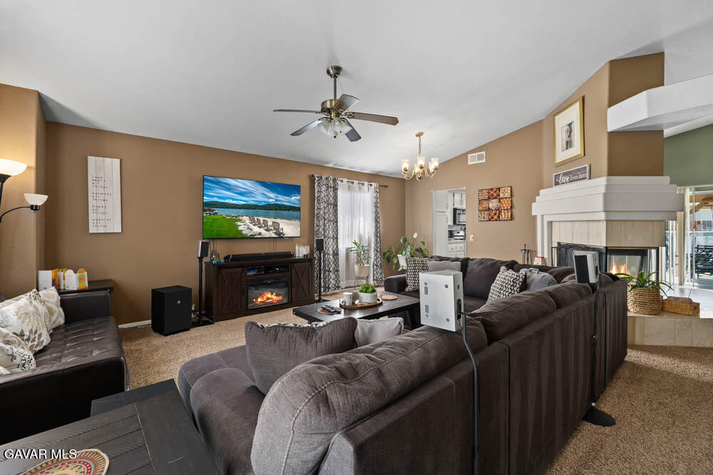 2425 Williams Court Rosamond, CA 93560 - Photo 6 of 35 a living room with furniture a fireplace and a flat screen tv