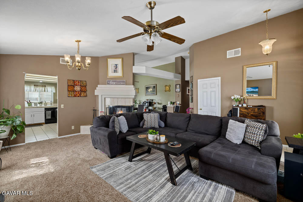 2425 Williams Court Rosamond, CA 93560 - Photo 8 of 35 a living room with furniture a chandelier and a dining table
