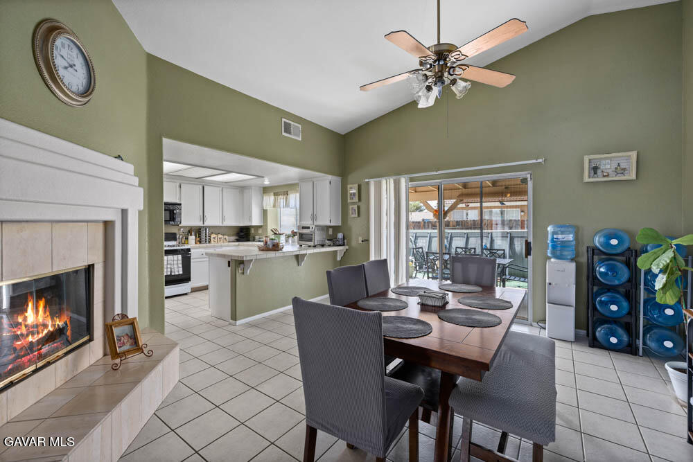 2425 Williams Court Rosamond, CA 93560 - Photo 10 of 35 a dining room with furniture and a fireplace