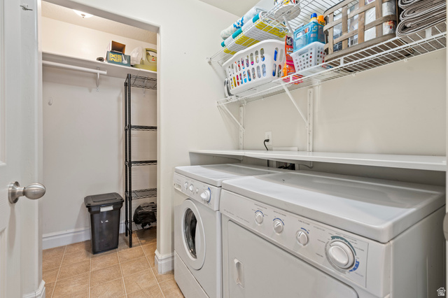 8248 South Resaca Drive, Unit J10 Sandy, UT 84070 - Photo 22 of 40 Dedicated laundry area featuring a washer and dryer, tile flooring, and a built-in shelf for organization