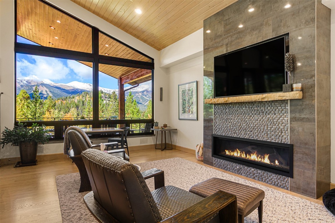 1031 Boreas Pass Road Breckenridge, CO 80424 - Photo 20 of 49 a living room with furniture a flat screen tv and a fireplace