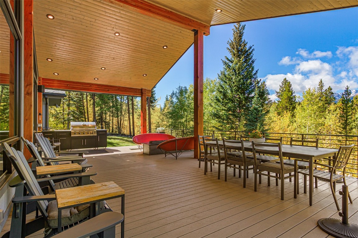 1031 Boreas Pass Road Breckenridge, CO 80424 - Photo 30 of 49 a view of a patio with dining table and chairs with wooden floor and fence
