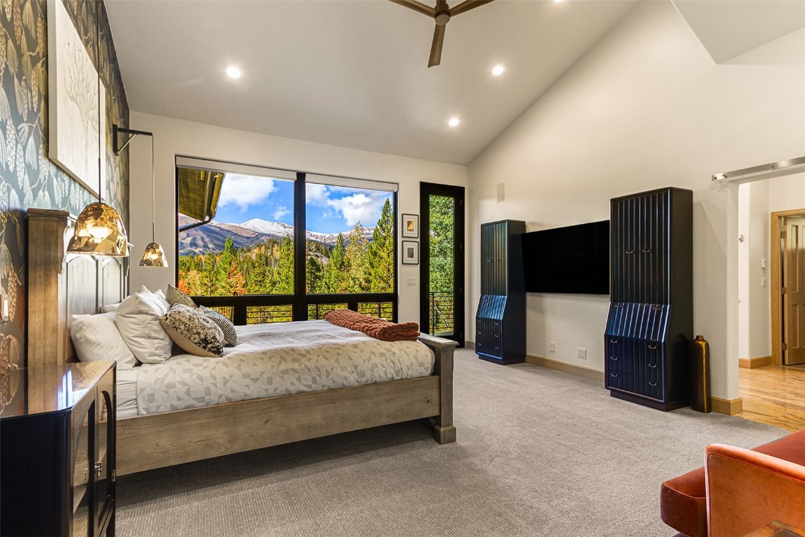 1031 Boreas Pass Road Breckenridge, CO 80424 - Photo 34 of 49 a bedroom with a bed dresser and a large window