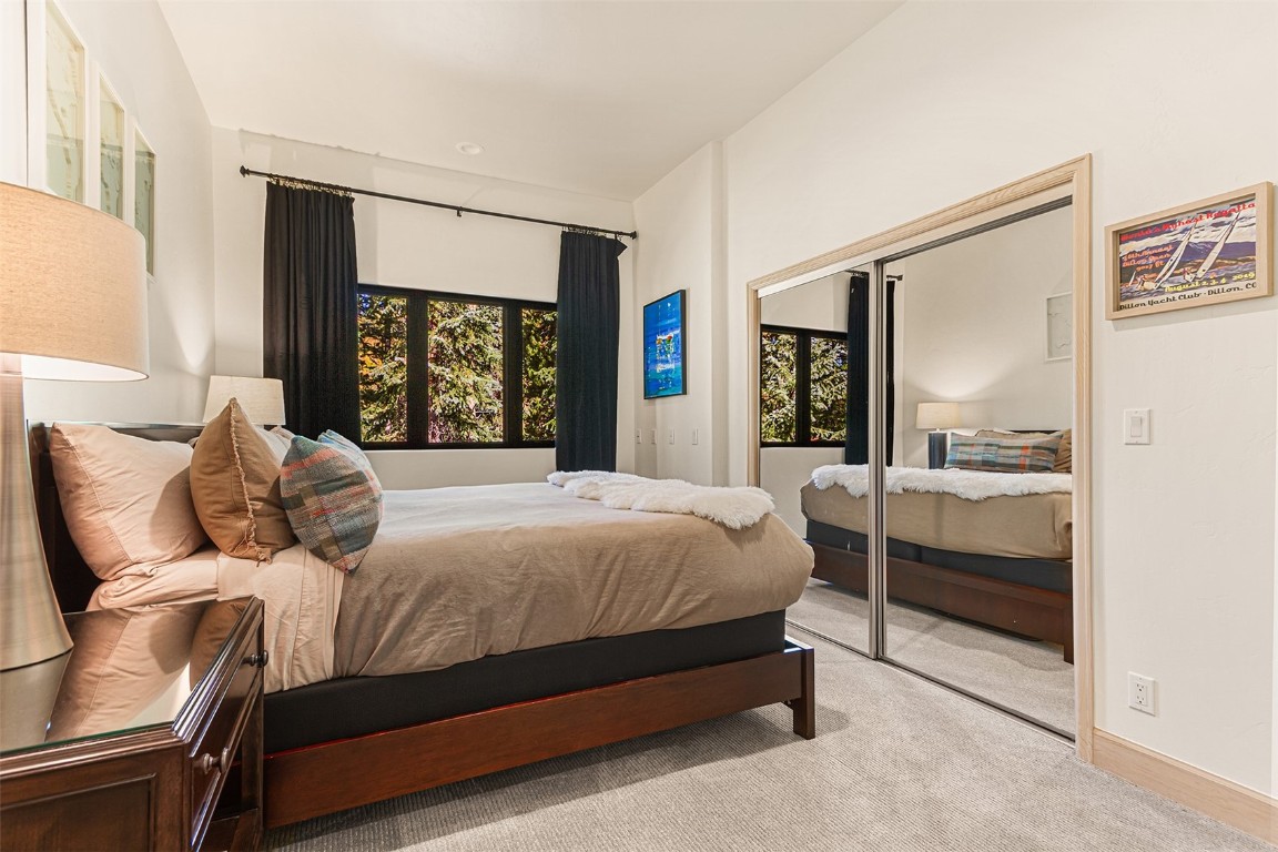 1031 Boreas Pass Road Breckenridge, CO 80424 - Photo 41 of 49 a bedroom with a bed and glass window