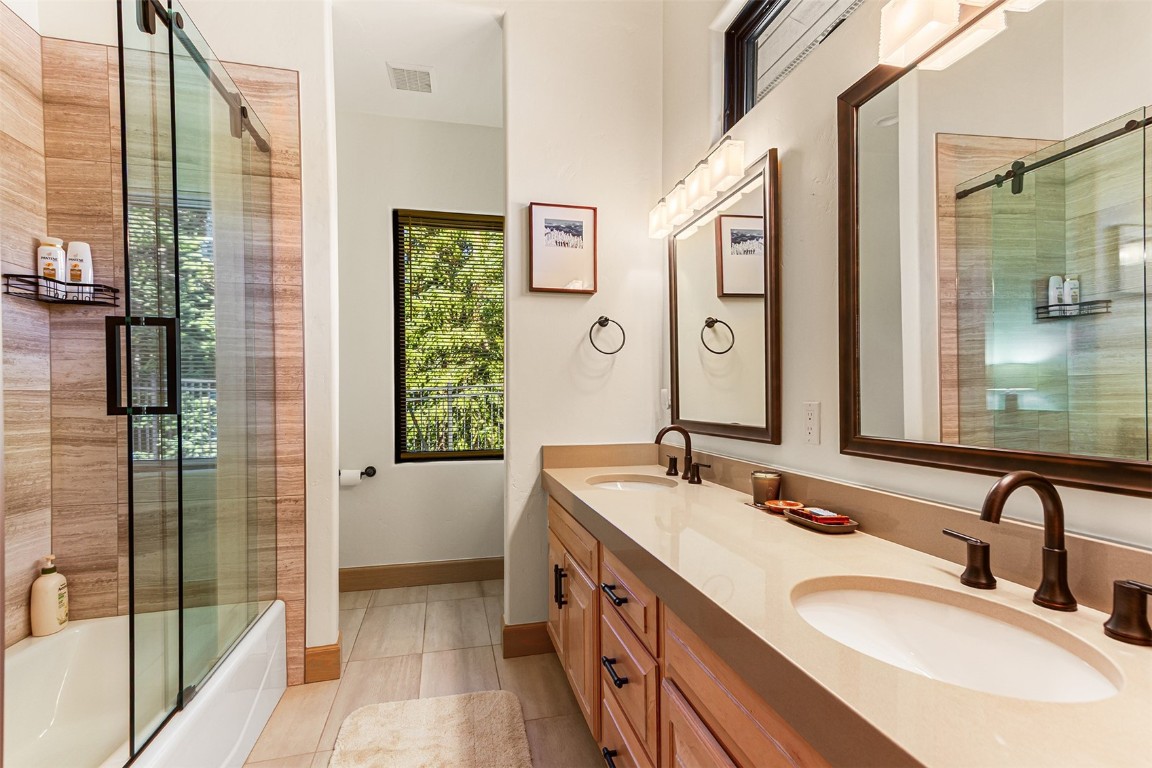 1031 Boreas Pass Road Breckenridge, CO 80424 - Photo 42 of 49 a bathroom with a double vanity sink toilet and shower