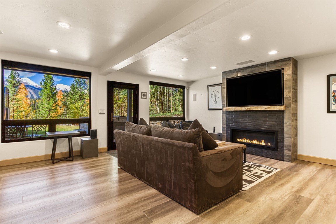 1031 Boreas Pass Road Breckenridge, CO 80424 - Photo 45 of 49 a living room with furniture a flat screen tv and a fireplace