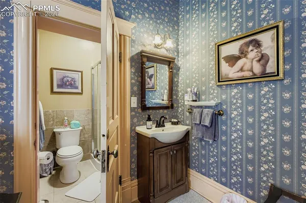 a bathroom with a sink mirror and toilet