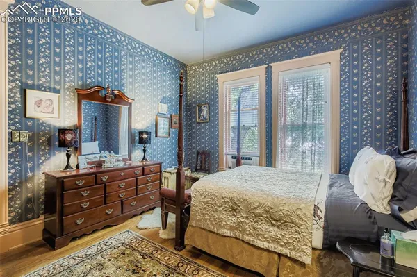 a bedroom with a bed and a chandelier