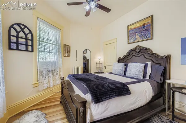 a bed sitting in a bedroom next to a window