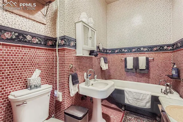 a bathroom with a sink mirror and toilet