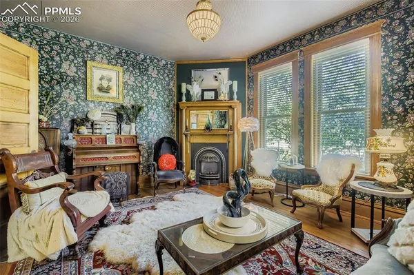a living room with fireplace furniture and a floor to ceiling window