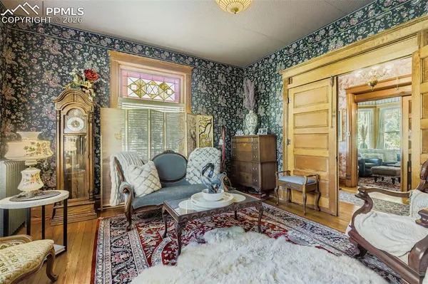 a living room with furniture wooden floor and a table