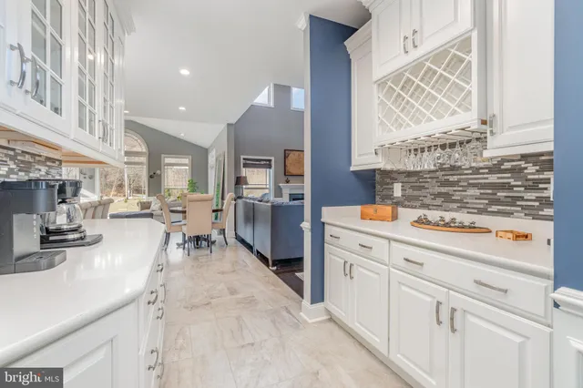a kitchen with a center island appliances and cabinets