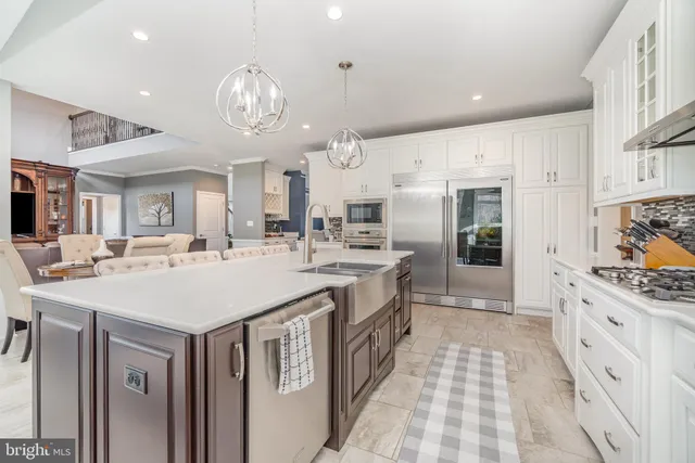 a large kitchen with a counter space and a view of living room