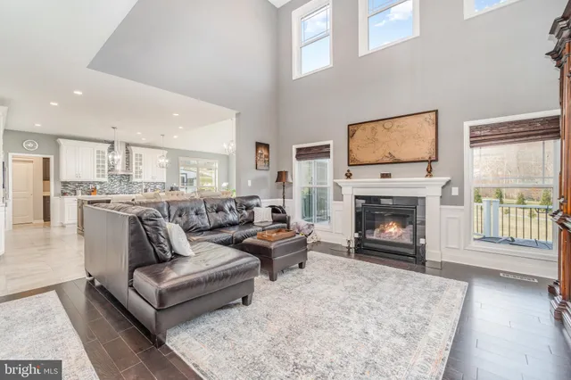 a living room with chairs and a dining table with rug