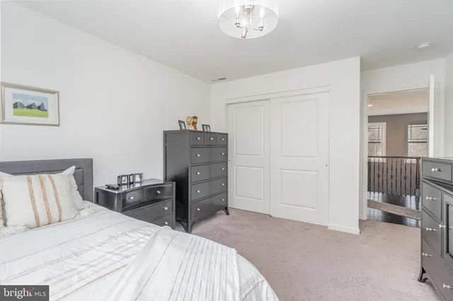 a bedroom with a bed and dresser