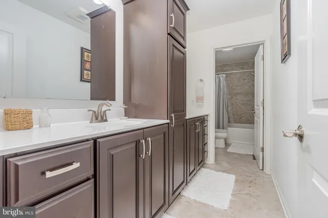 a view of a livingroom with workspace and a flat screen tv