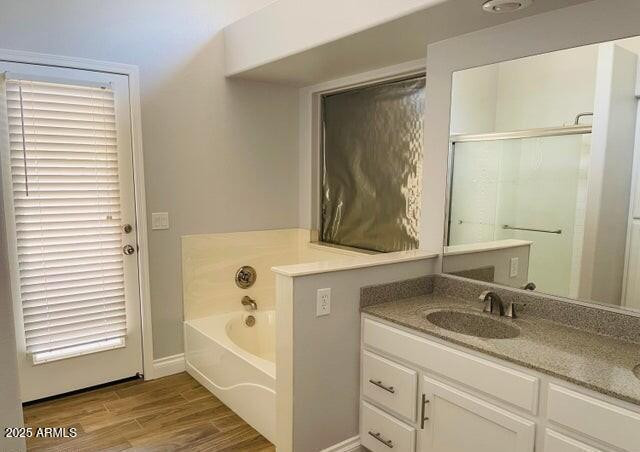 12817 West Alvarado Road Avondale, AZ 85392 - Photo 14 of 15 a bathroom with a granite countertop sink a mirror and a bathtub