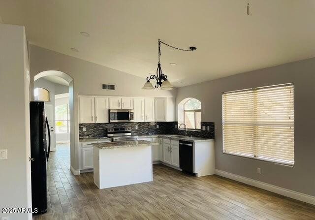 12817 West Alvarado Road Avondale, AZ 85392 - Photo 2 of 15 a kitchen with granite countertop a stove top oven a sink a counter space and cabinets