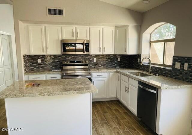 12817 West Alvarado Road Avondale, AZ 85392 - Photo 3 of 15 a kitchen with stainless steel appliances granite countertop a stove a sink and a microwave
