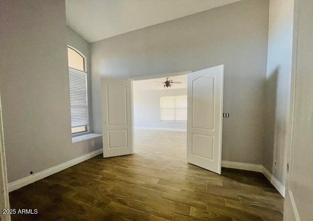 12817 West Alvarado Road Avondale, AZ 85392 - Photo 8 of 15 a view of an empty room with window and wooden floor