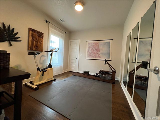 a room with gym equipment and a view of living room