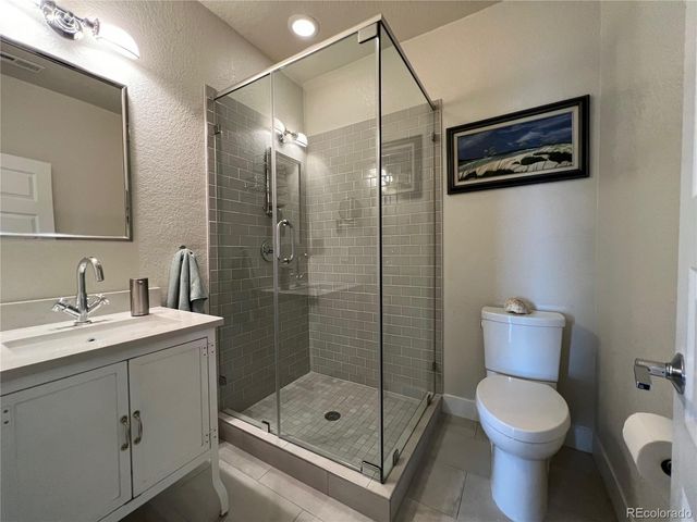 a bathroom with a toilet sink and shower