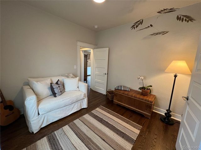 a bedroom with furniture and a wooden floor