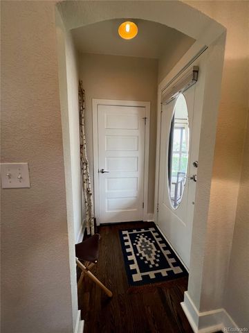 a view of a livingroom with wooden floor and white walls
