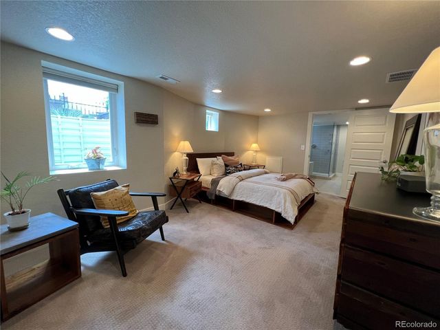 a bedroom with furniture and a window