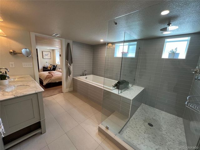 a bathroom with a tub sink and mirror
