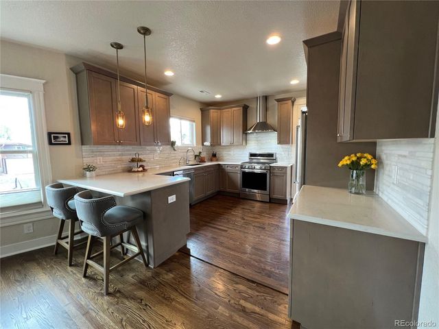 a kitchen with a sink appliances and cabinets