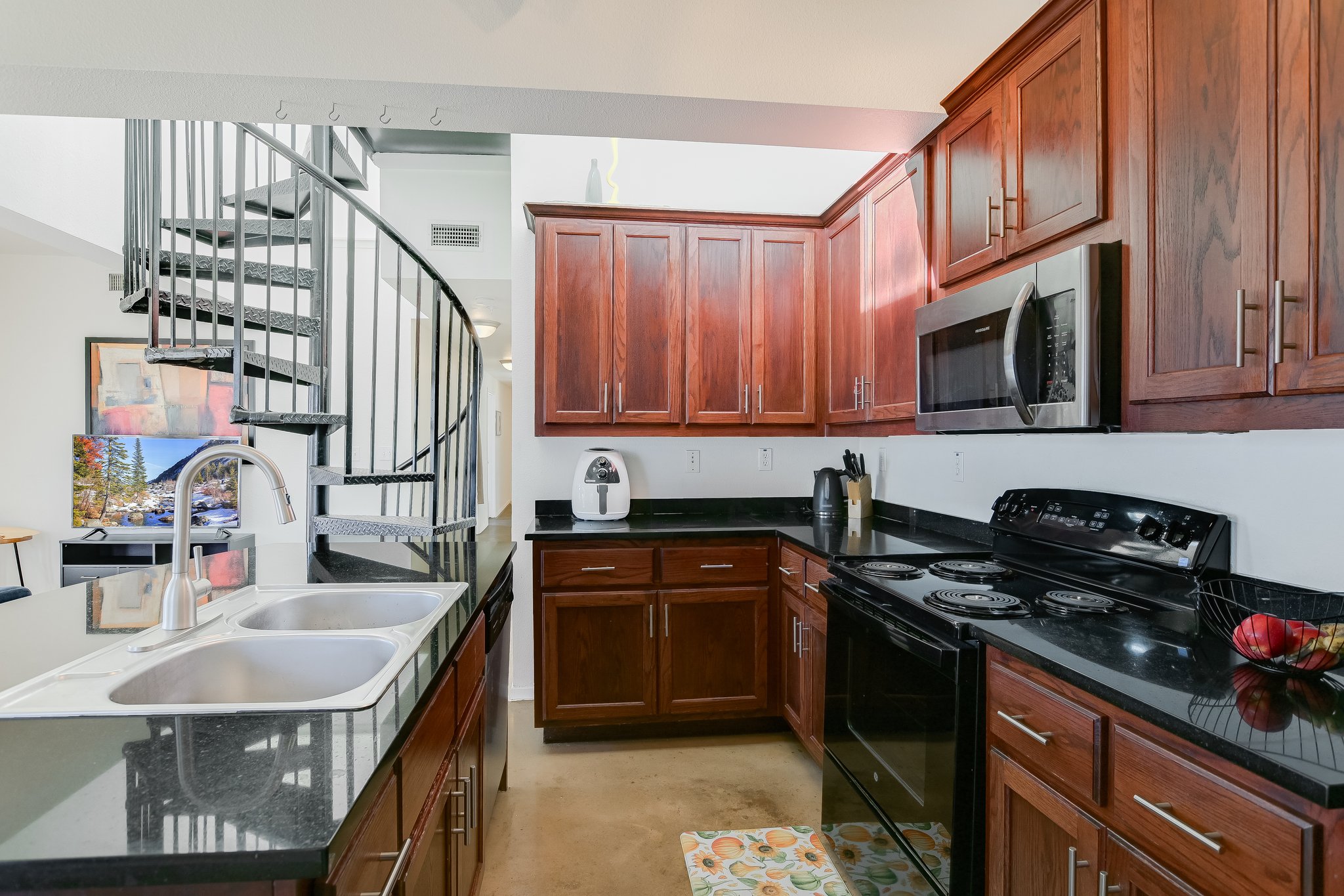 910 West 25th Street, Unit 607 Austin, TX 78705 - Photo 11 of 19 Kitchen with stainless steel appliances and dark stone countertops