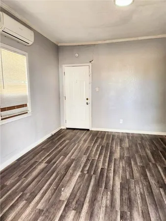a view of a room with wooden floor and white walls