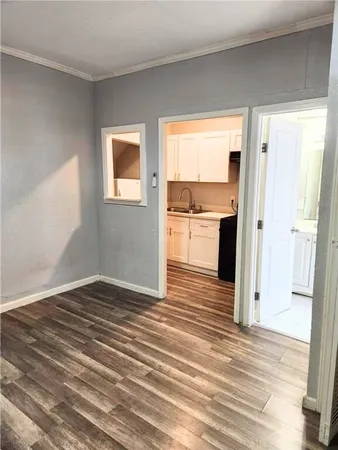 a view of a kitchen from a hallway