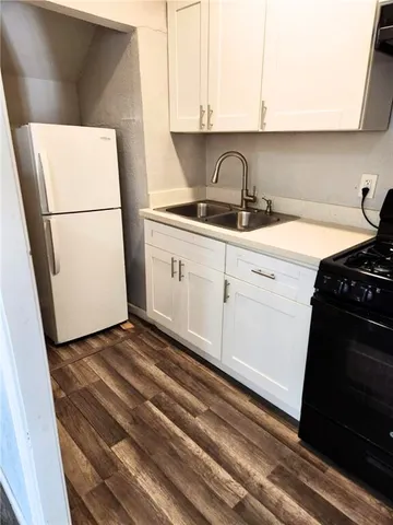 a kitchen with a refrigerator stove and cabinets