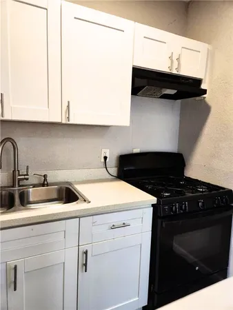 a kitchen with a sink and cabinets