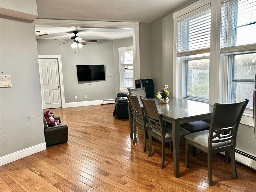 139 Park Street, Unit 4 Chelsea, MA 02150 - Photo 3 of 11 a view of a dining room with furniture and wooden floor
