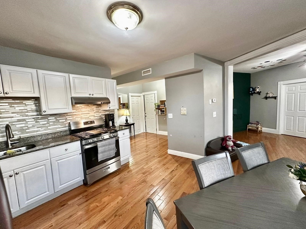 139 Park Street, Unit 4 Chelsea, MA 02150 - Photo 4 of 11 a large kitchen with cabinets