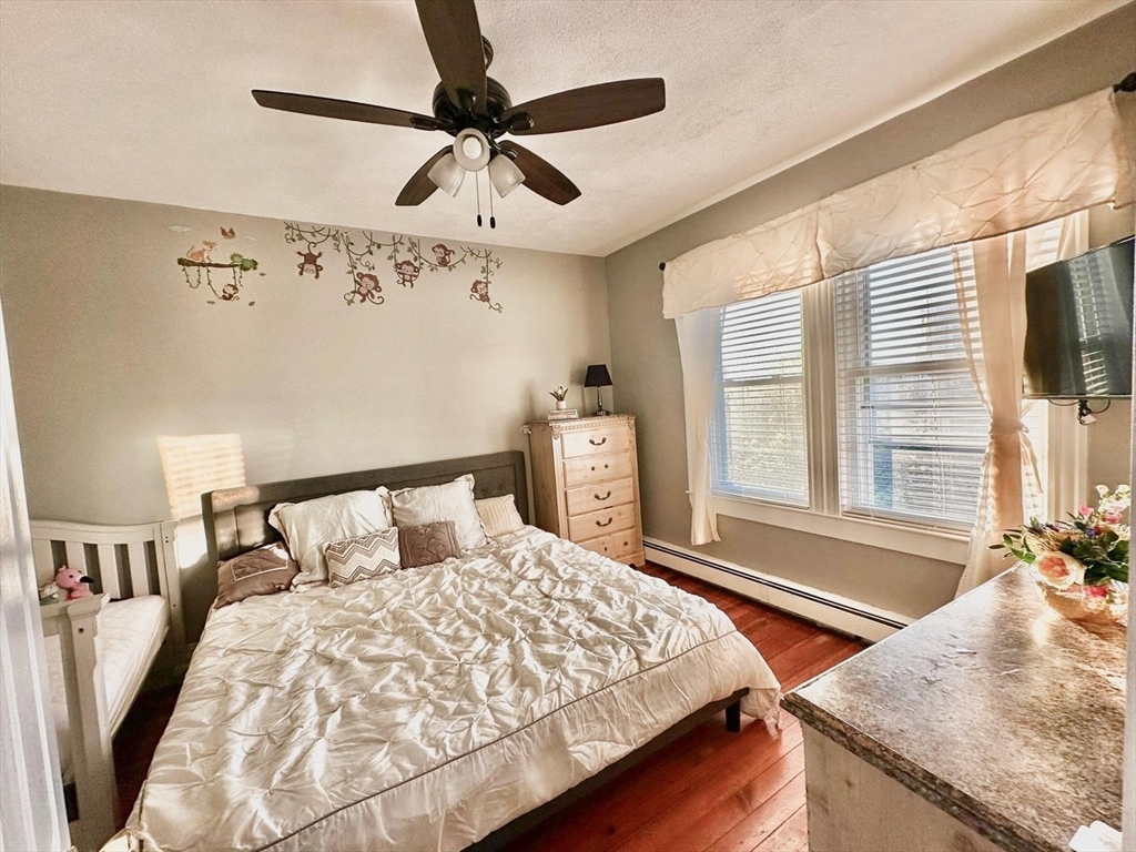 139 Park Street, Unit 4 Chelsea, MA 02150 - Photo 6 of 11 a bedroom with bed and window