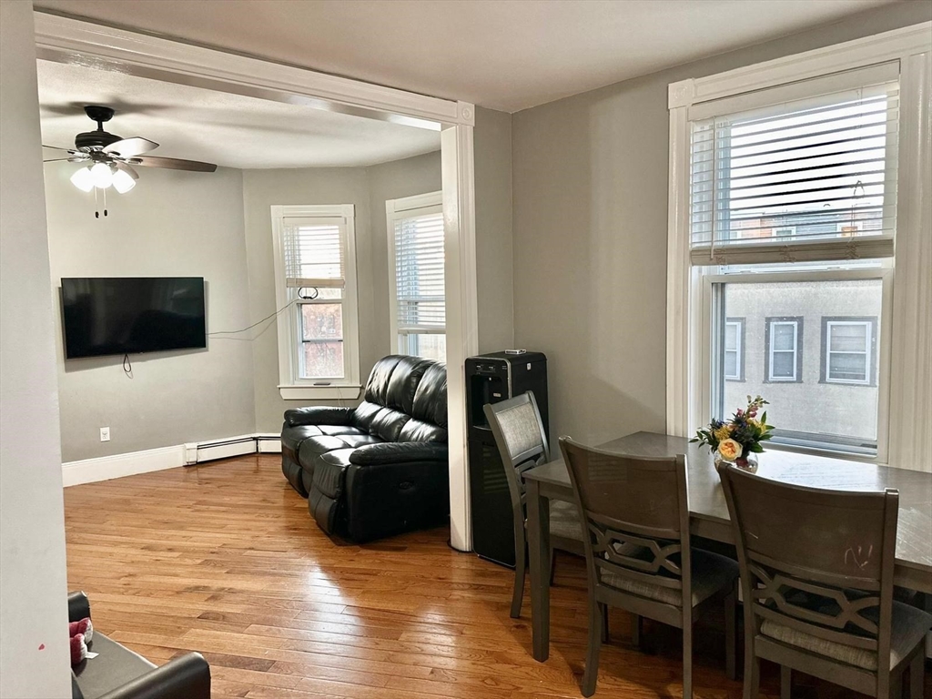 139 Park Street, Unit 4 Chelsea, MA 02150 - Photo 9 of 11 a living room with furniture a flat screen tv and a window