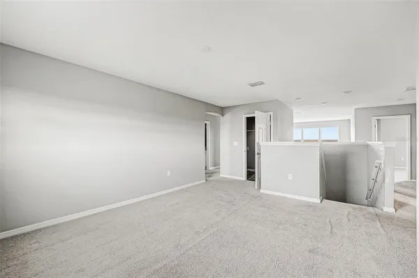 a view of a big room with closet and windows