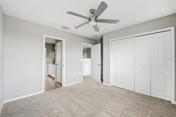 a view of a livingroom with a ceiling fan & a ceiling fan