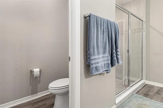 a bathroom with a granite countertop bathtub and toilet