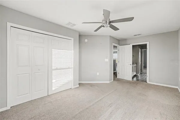 a view of empty room with ceiling fan