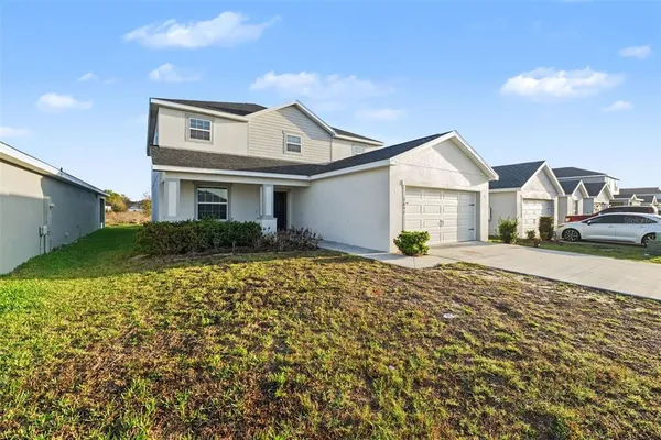 a front view of a house with a yard