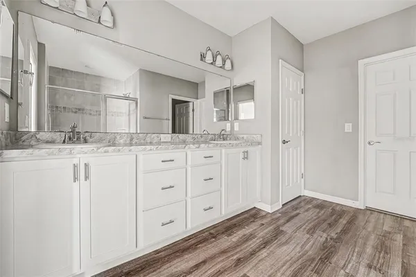a bathroom with a granite countertop sink and a mirror