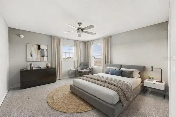 a spacious bedroom with a bed a dresser and a couch